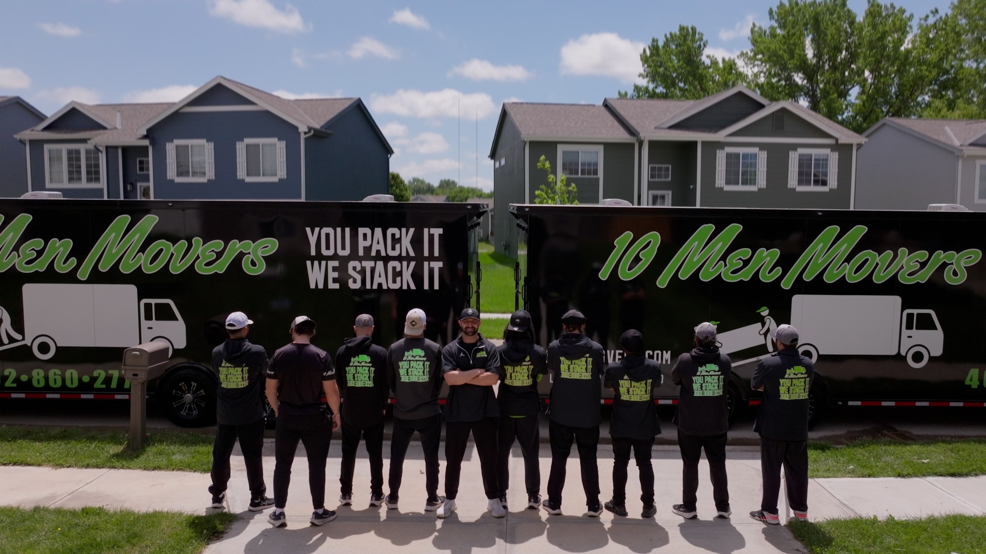 10 Men Movers professional crew standing in front of moving trucks